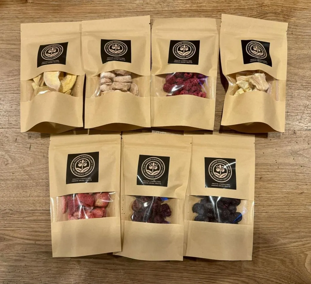 The very first Crunchy Orchard bags from October 2024: seven kraft pouches with labels applied by hand
